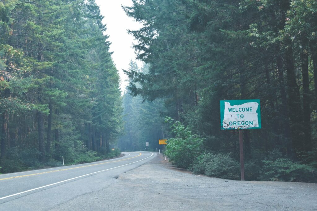 Welcome to Oregon road sign in a forest