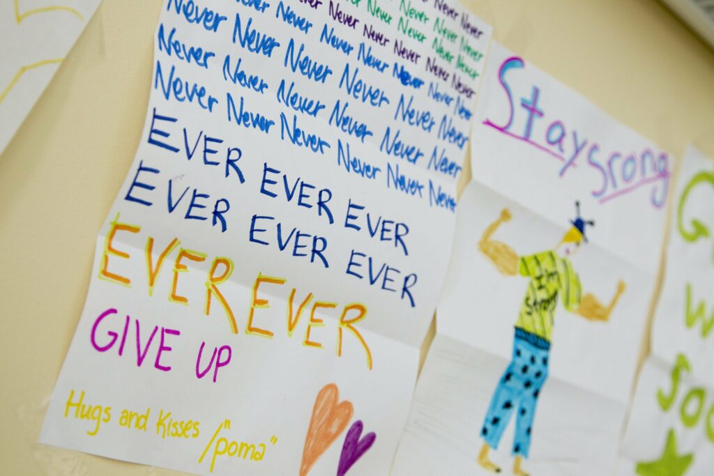 Paper drawings taped to wall saying Never Never Never Never Never ever ever give up